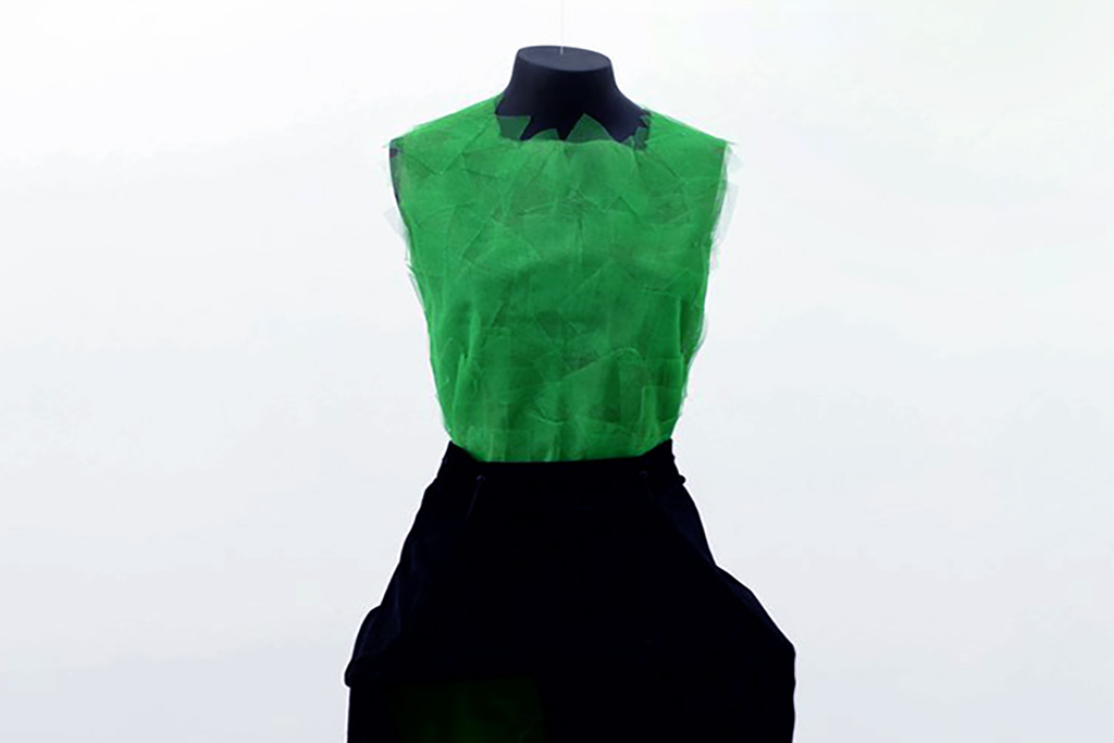 detail shot of a dress with green fabric and velvet interactive skirt
