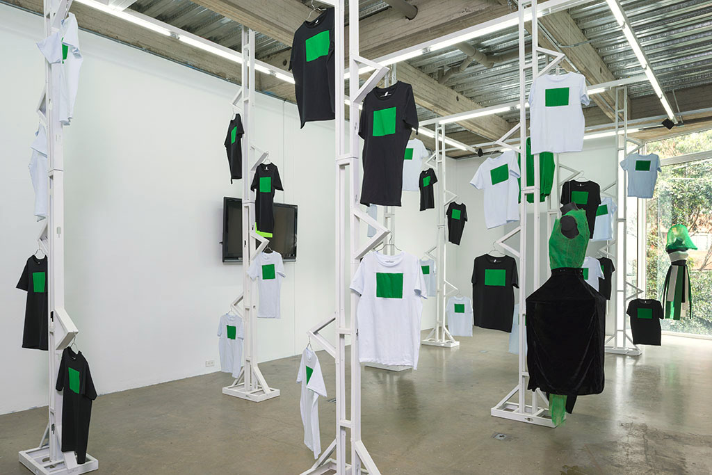 first floor again exhibition at Espacio el Dorado, t shirts with green screen hanged around the space