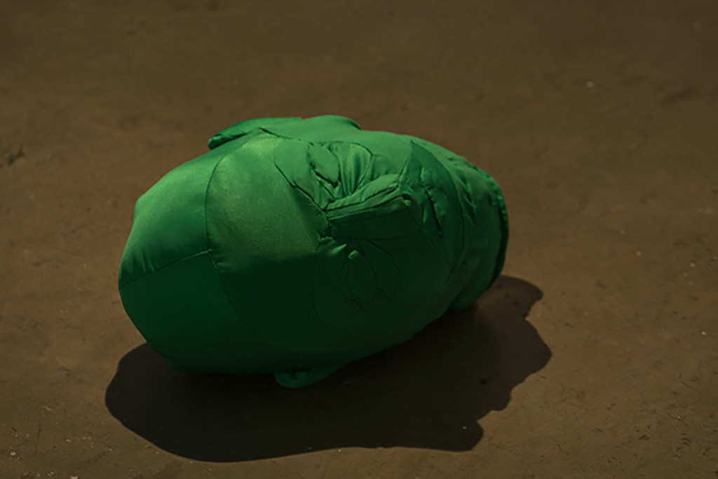Close up showing a green screen prop head on the floor