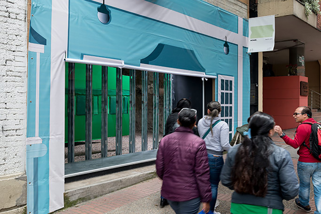Facade of Espacio el Dorado in Bogota witha modern Potemkin facade printed in banner, an openning on the printed banner shows the inside of the third floor of the exhibition