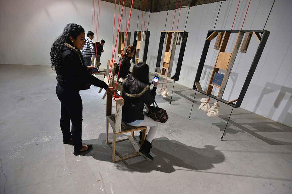 Visitors interacting with sculptures at the exhibition titled machine