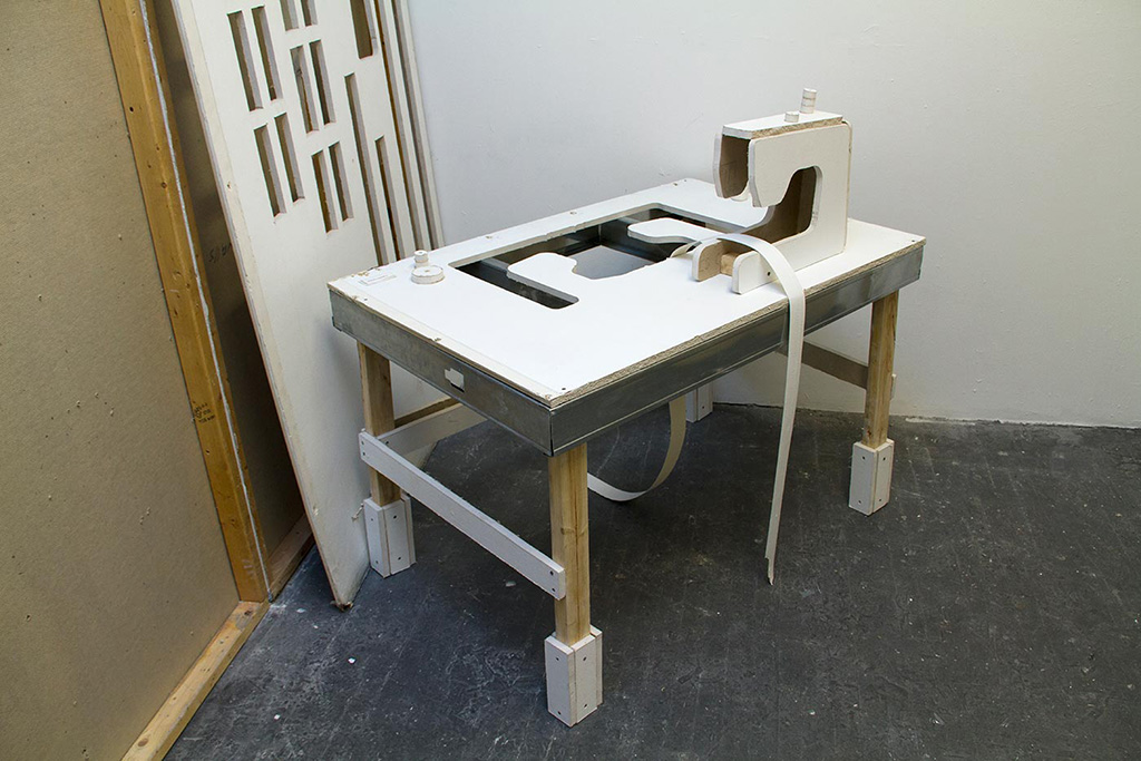 Installation of a sewing machine made out of sheetrock.